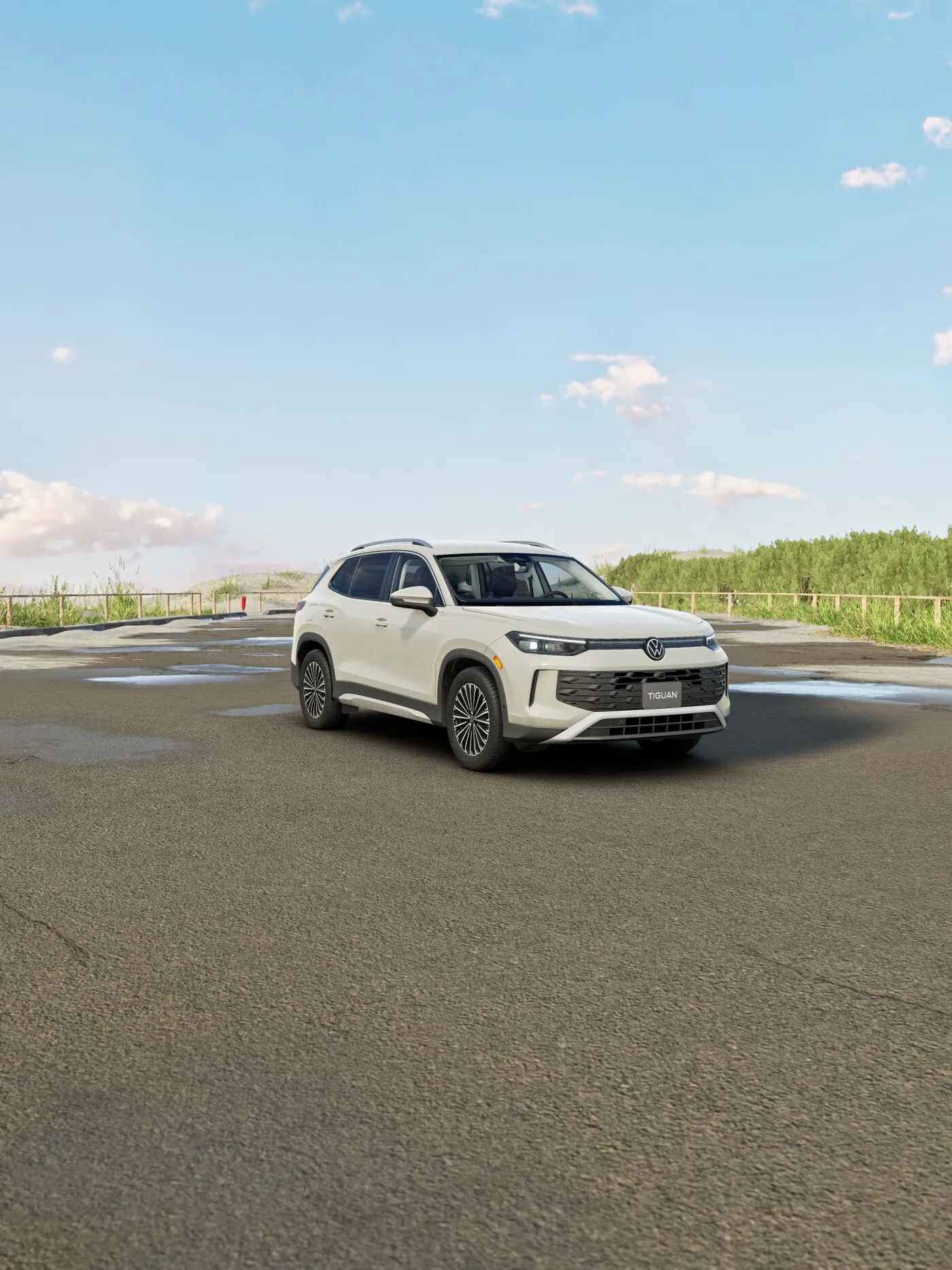White Volkswagen Tiguan Comfortline parked on an open road under a blue sky.