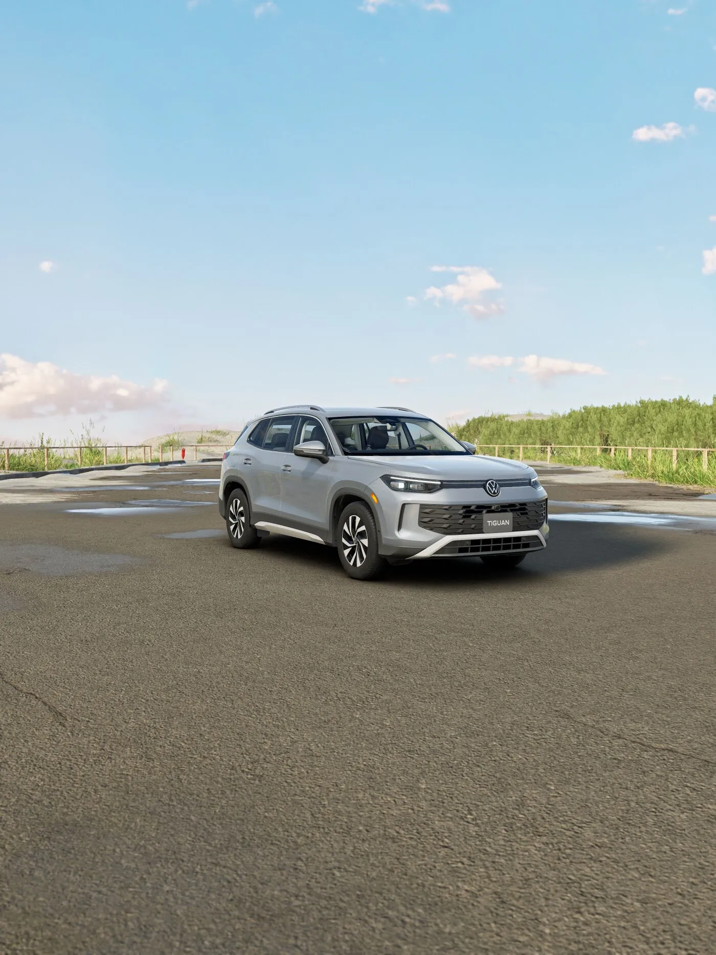 White Volkswagen Tiguan Trendline parked on an open road under a blue sky.