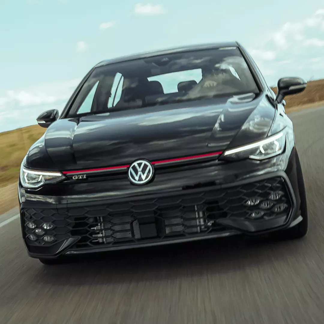 Black Volkswagen Golf GTI in dynamic driving to choose a reliable sedan based on your needs.