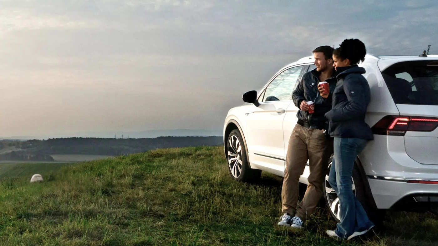 Drivers near a Volkswagen vehicle, a scene showing how to choose a car based on needs.