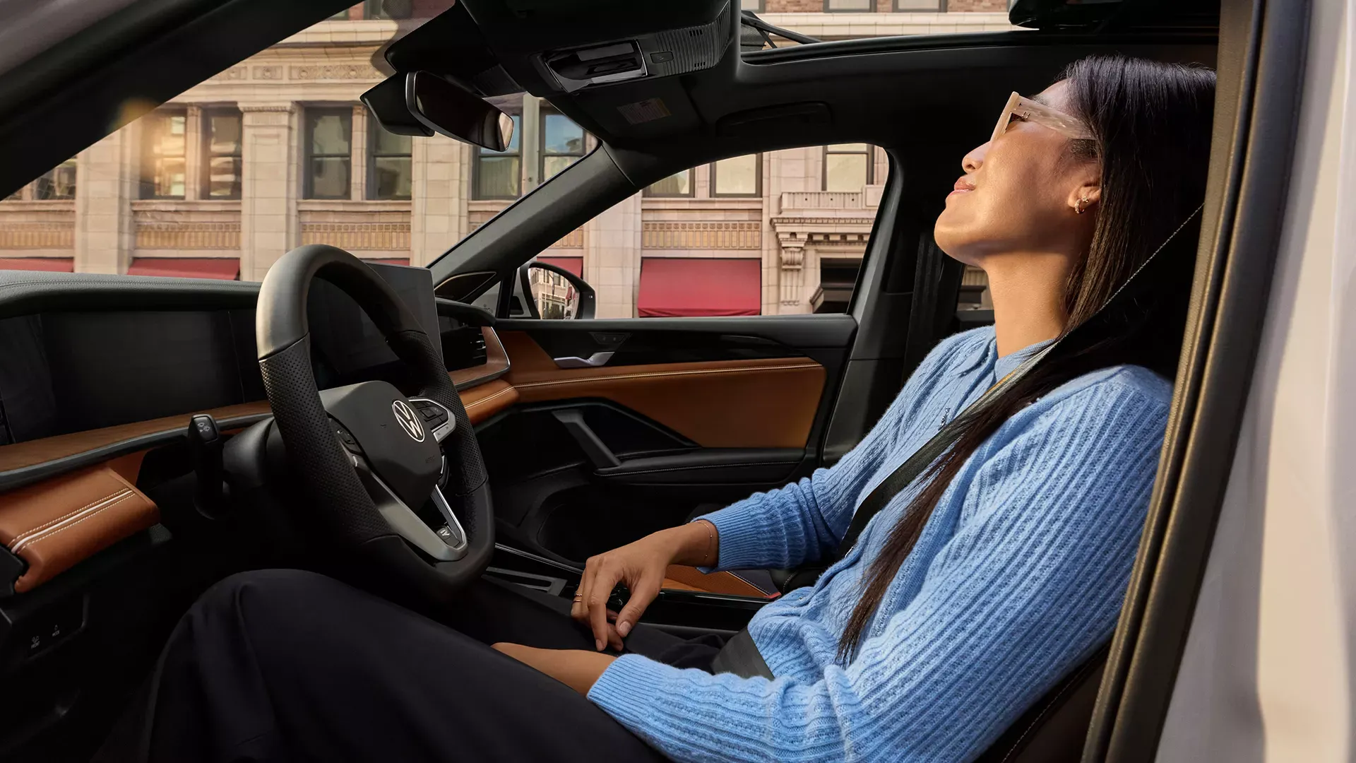 Driver inside a Volkswagen vehicle, to compare the comfort of a sedan and an SUV.