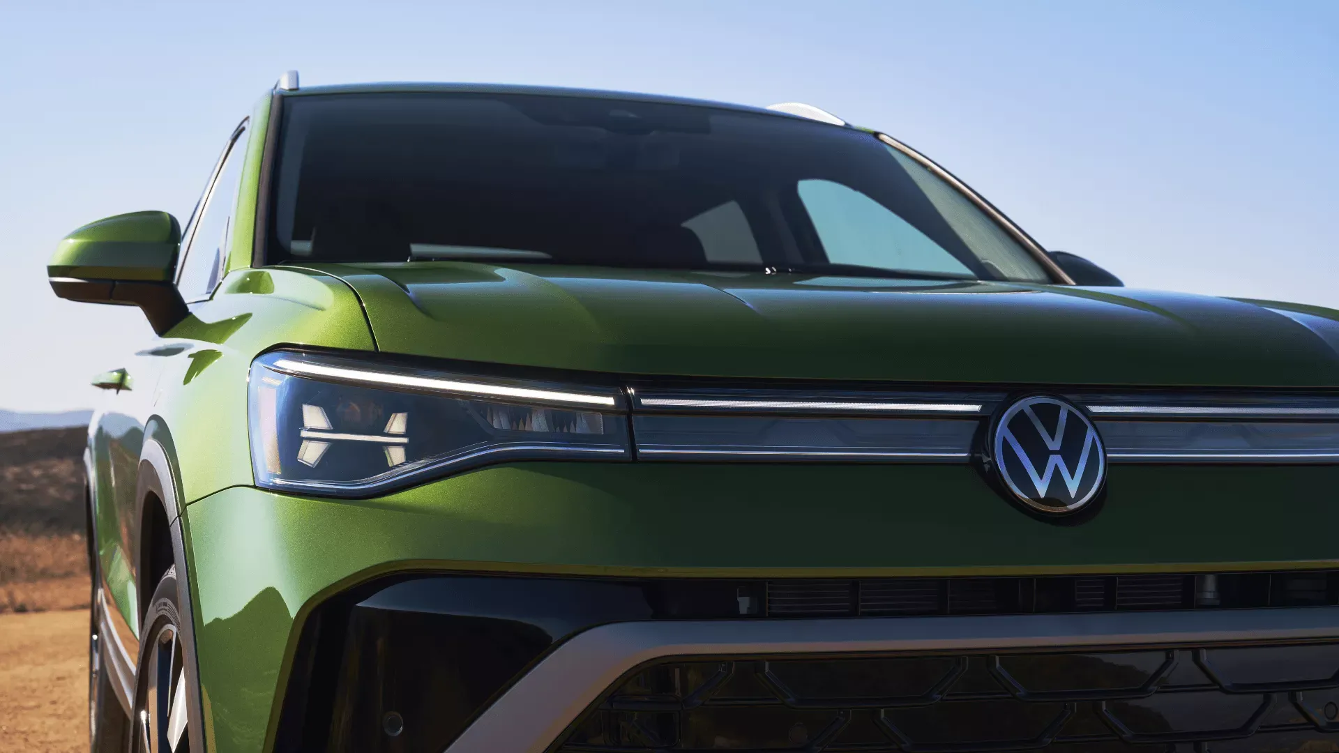 Green 2026 Volkswagen Taos seen from the front.