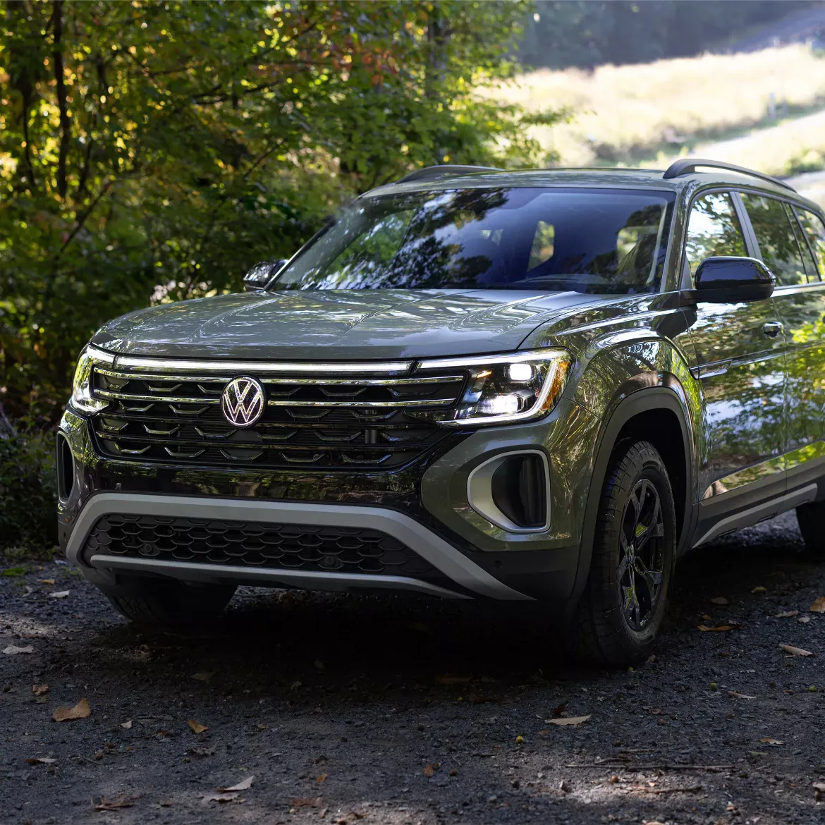 2026 Volkswagen Atlas on a forest road.