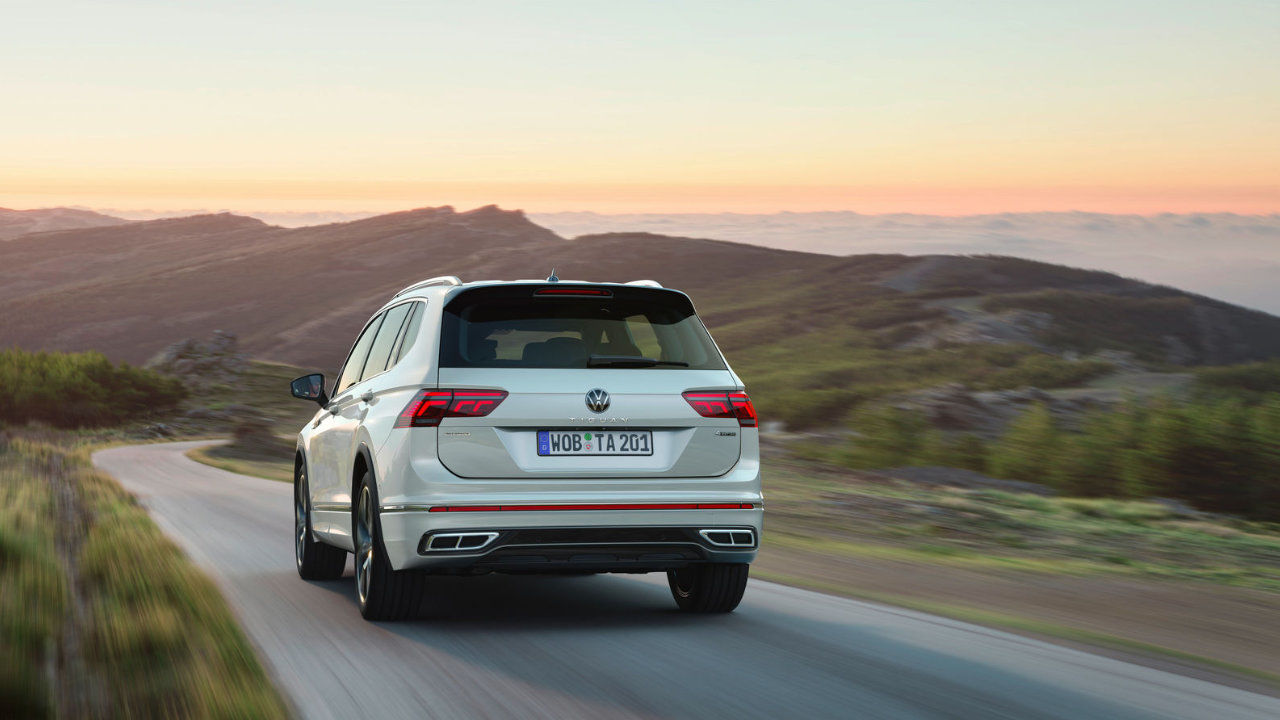 Rear view of the 2023 Volkswagen Tiguan driving on a mountain road.