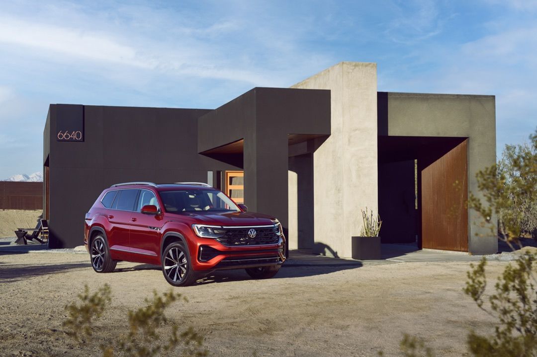 front side view of a 2024 VW Atlas in front of a modern house