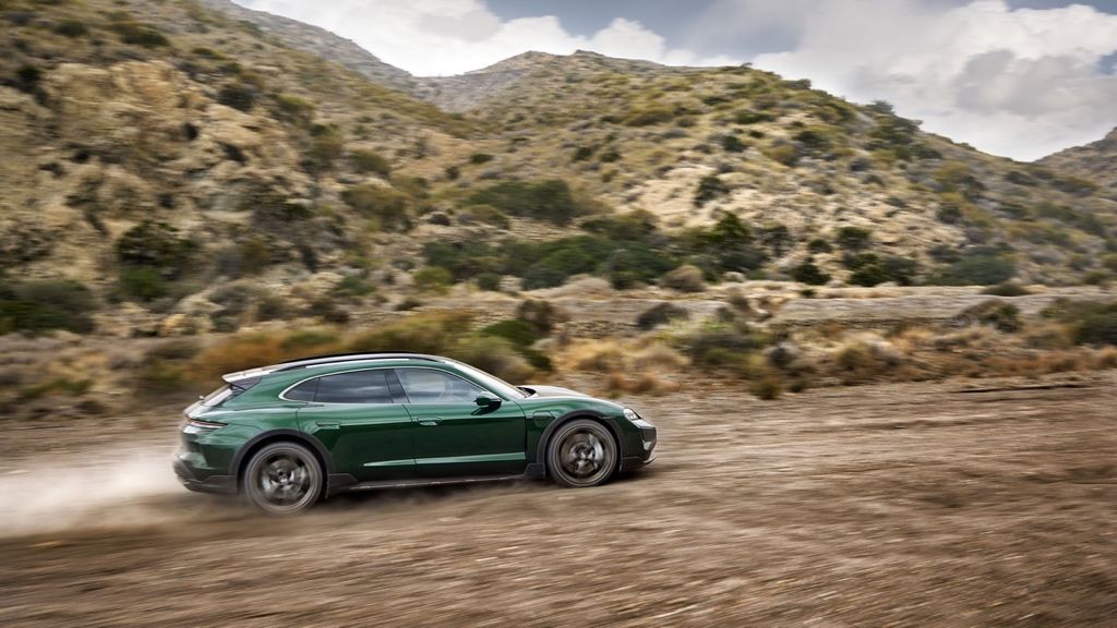 Side view of the 2025 Porsche Taycan driving at full power.