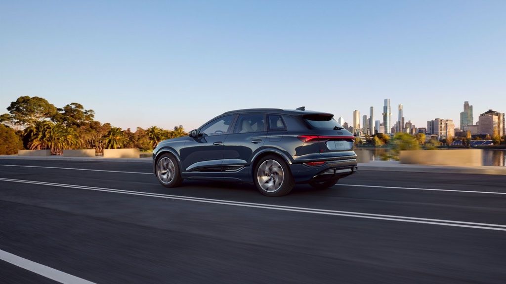 3/4 rear view of the 2025 Audi Q6 e-tron on the road.