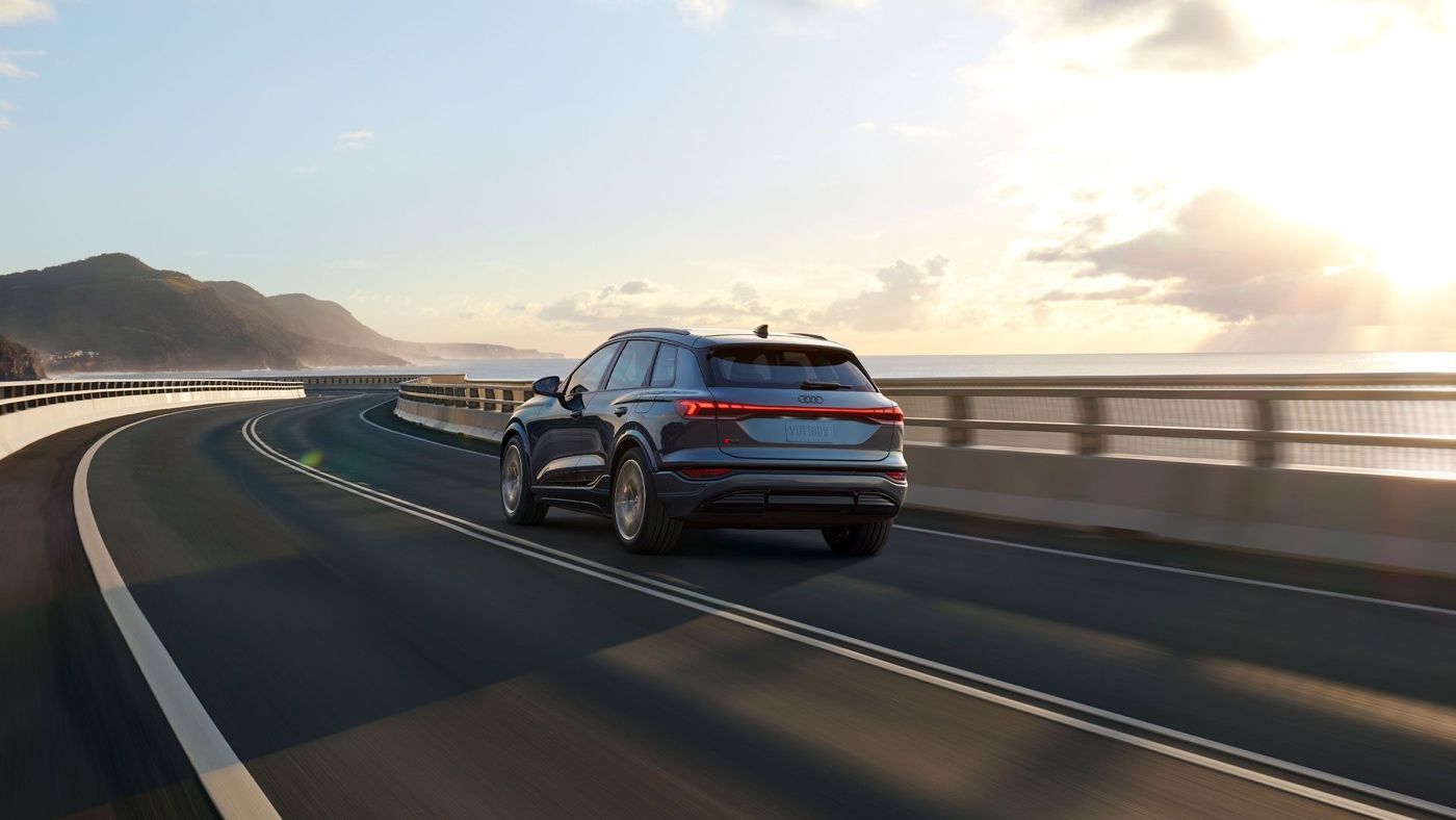 3/4 rear view of the 2025 Audi Q6 e-tron on the road.