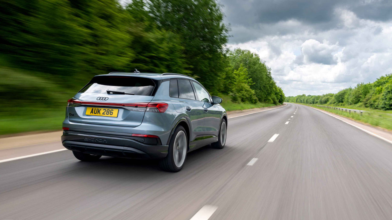 rear side view of a 2025 Audi Q4 e-tron on a country road