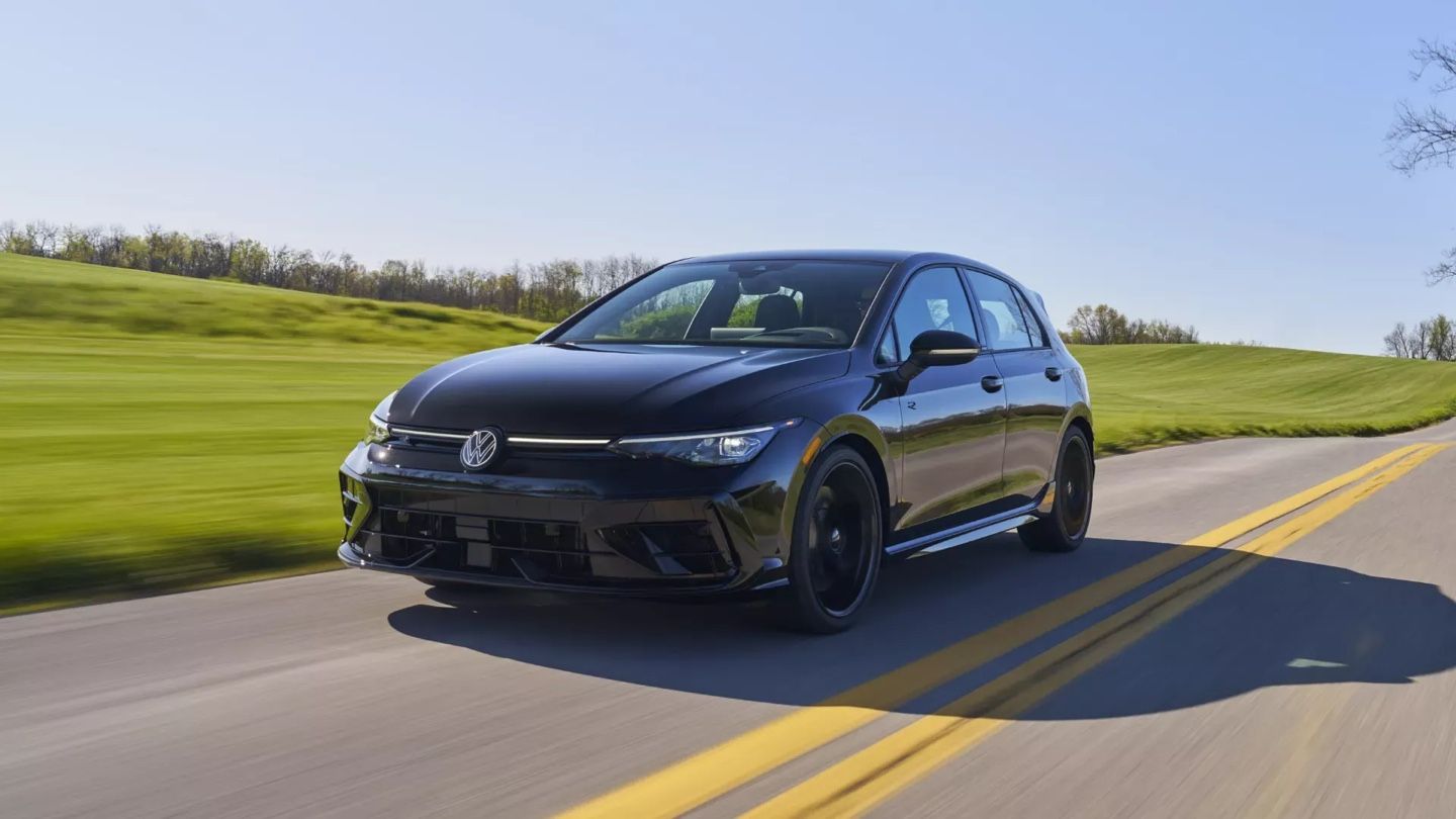 Volkswagen Golf R 2026 noire en mouvement sur route ensoleillée, démontrant ses performances haut de gamme reconnues par MotorTrend.