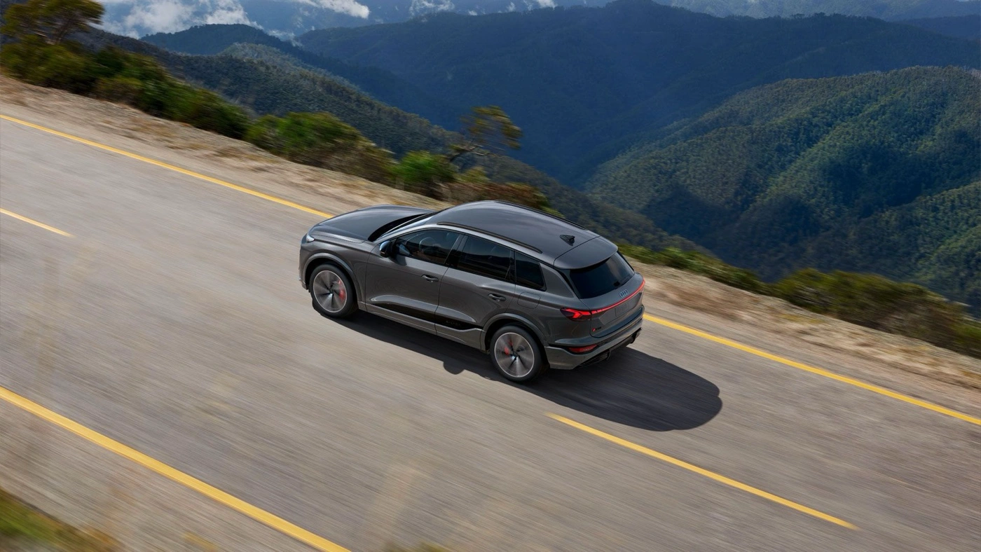 Version SQ6 roulant sur route de montagne pour illustrer la fiche technique de l&rsquo;Audi Q6 e-tron 2026.