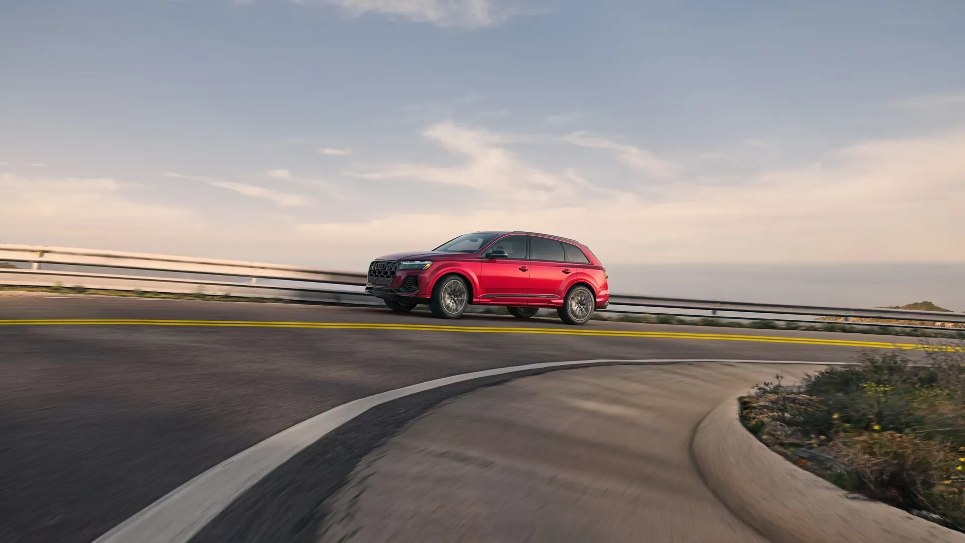 Red 2026 Audi SQ7 driving on the road to illustrate the specifications, engine and performance.