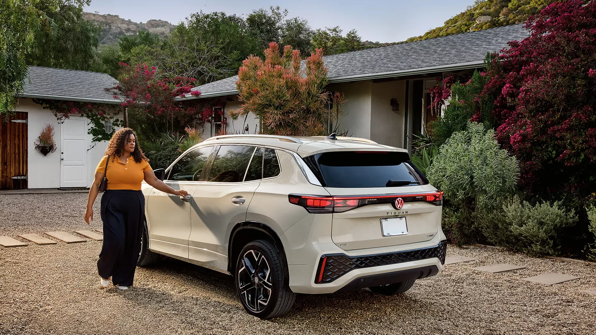 White 2026 Volkswagen Tiguan seen from the rear in front of a residence to conclude the article on pricing and the technical sheet.