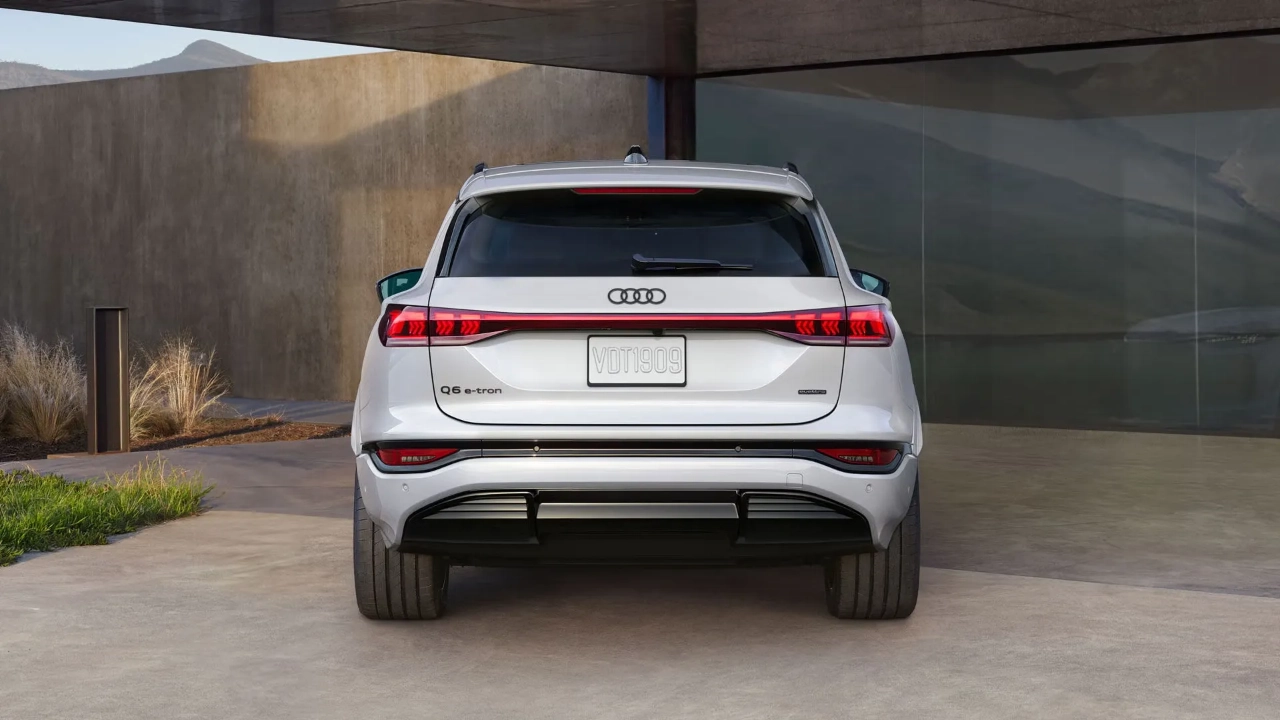 Rear view of the Audi Q6 e-tron showcasing its full-width LED light bar