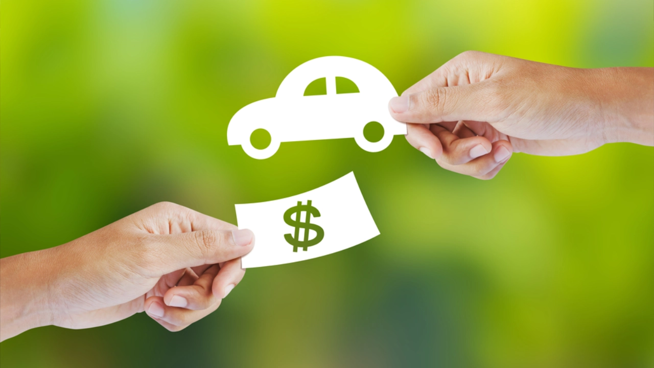 Two people shaking hands in a bright office environment to conclude a car sale