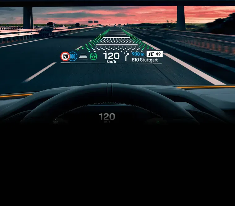 2027 Porsche Cayenne electric coupe augmented-reality head-up display showing highway navigation guidance.