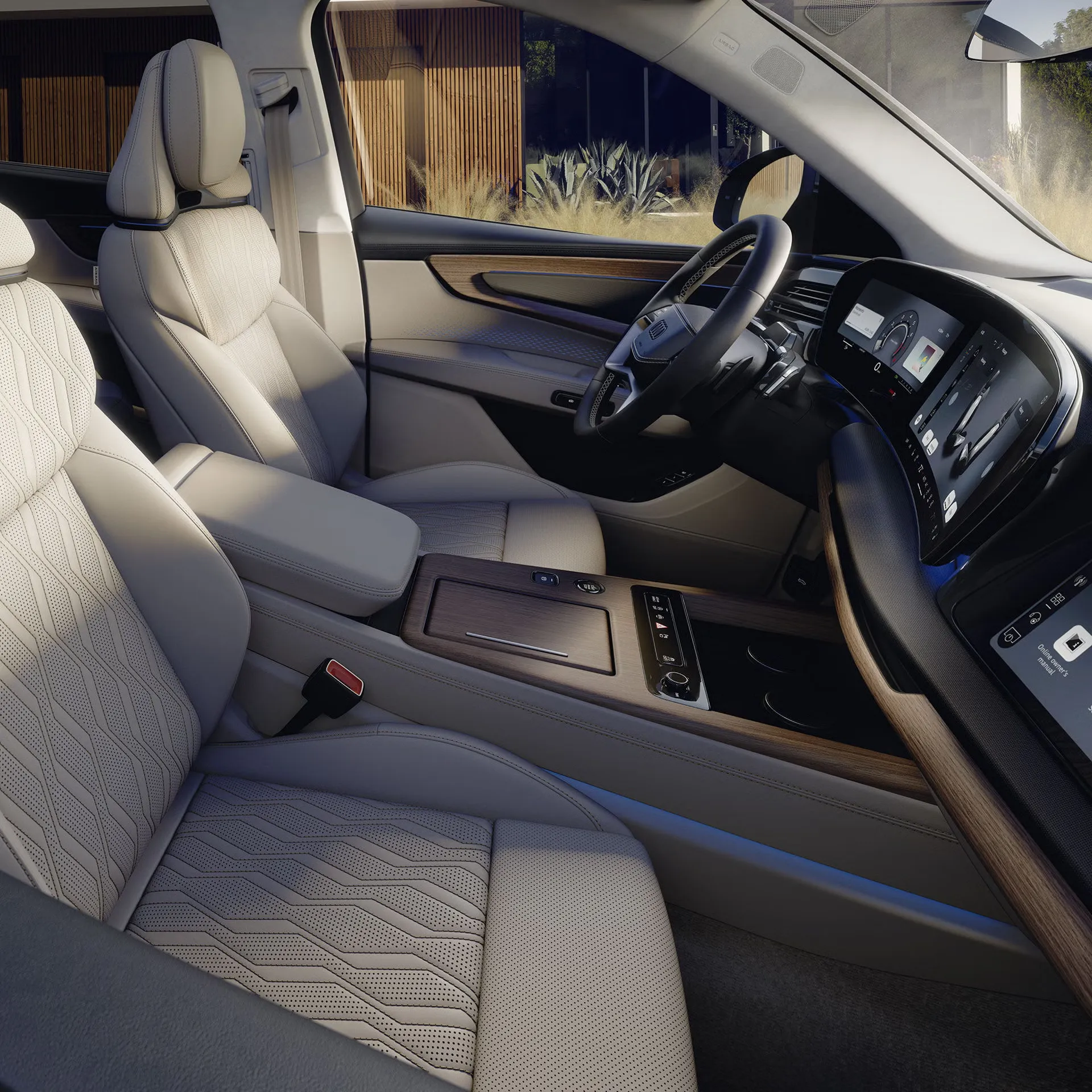 Front cabin of the 2027 Audi Q7 with light leather seats, steering wheel and centre console.