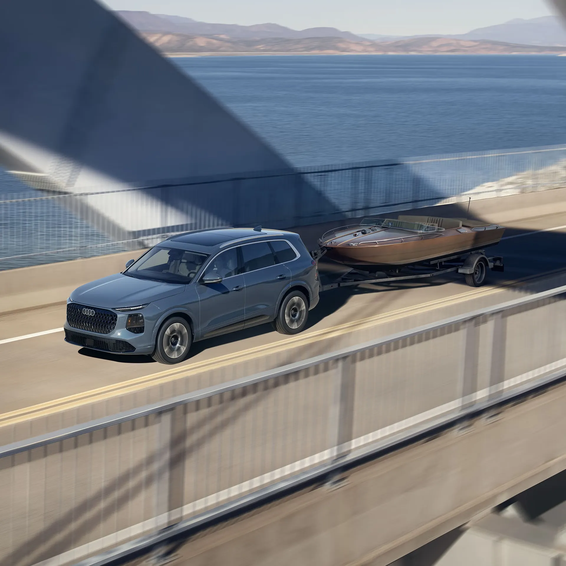 Blue 2027 Audi Q7 towing a boat across a bridge.