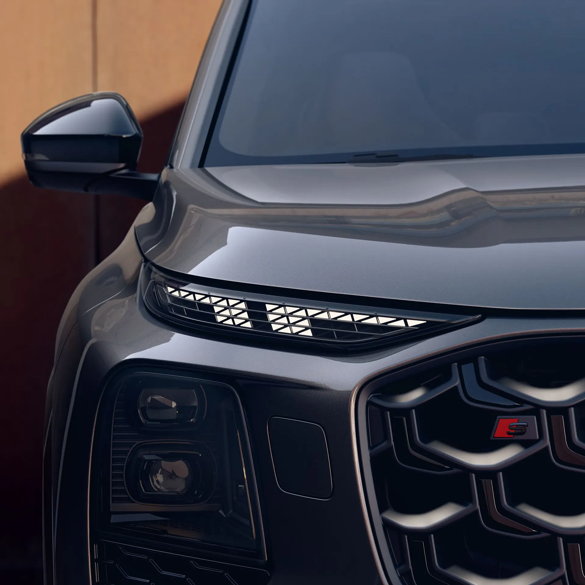 Detail of the front headlight and grille of the 2027 Audi SQ7 with its S badge.