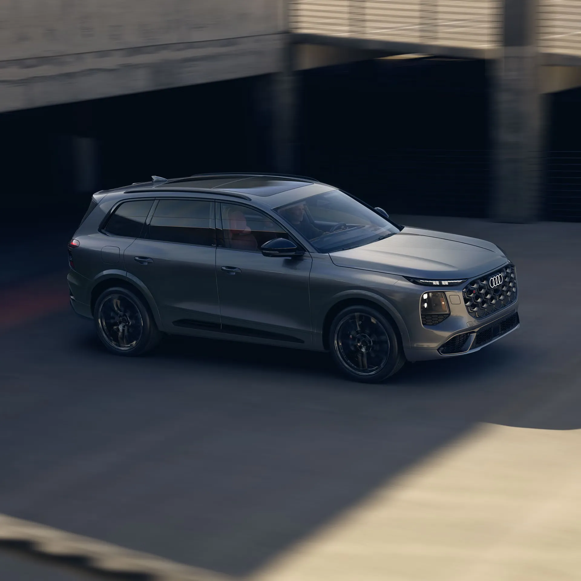 Grey 2027 Audi SQ7 in motion, viewed from a front three-quarter angle on the road.