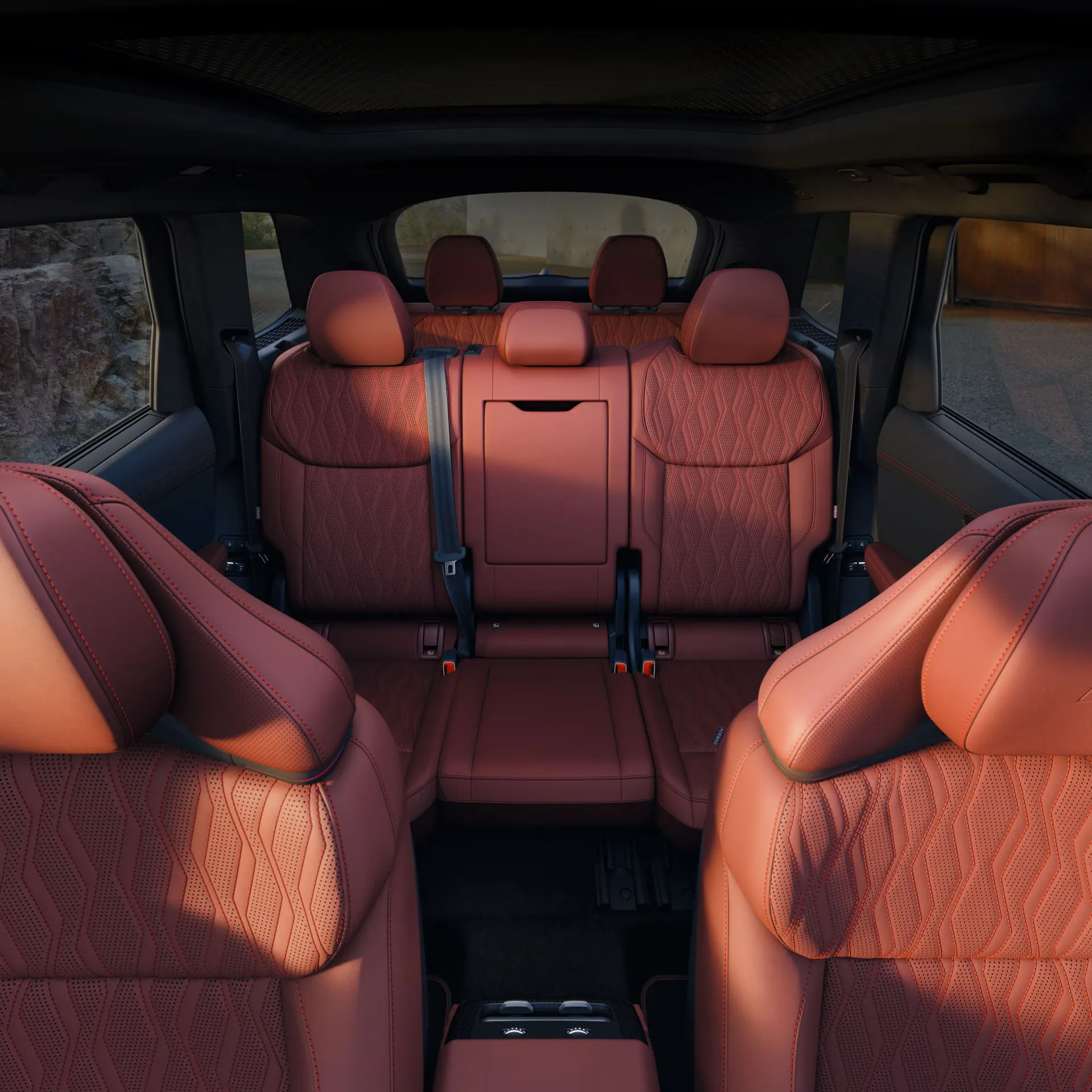 Red leather seats and rear seating rows of the 2027 Audi SQ7, viewed from the front of the cabin.