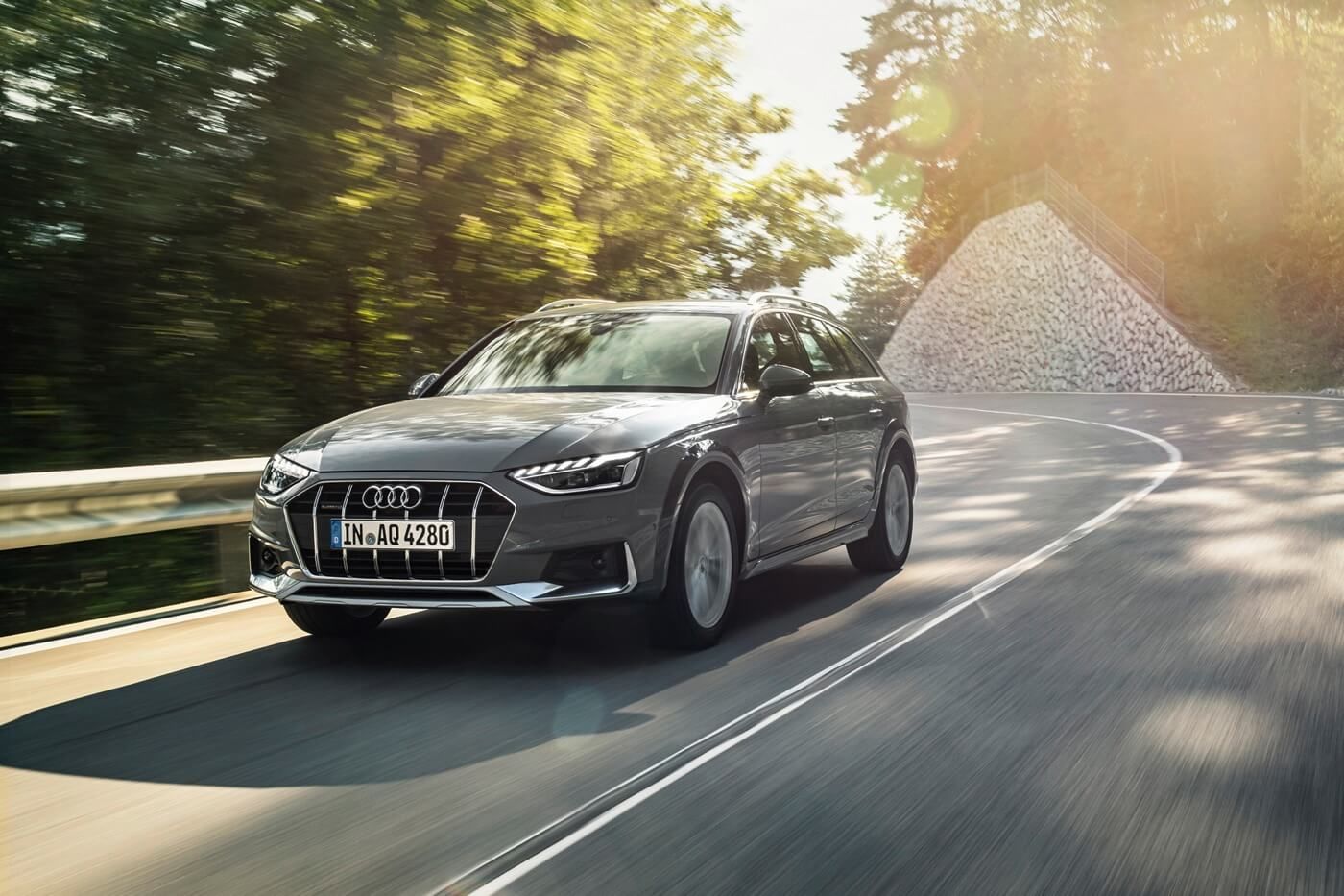 Front 3/4 view of an Audi A4 allroad driving on a road