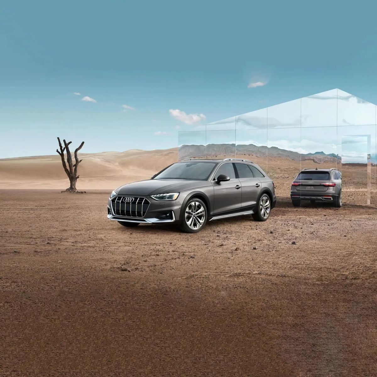 Front 3/4 view of an Audi A4 allroad quattro with its back to a mirror parked in a desert