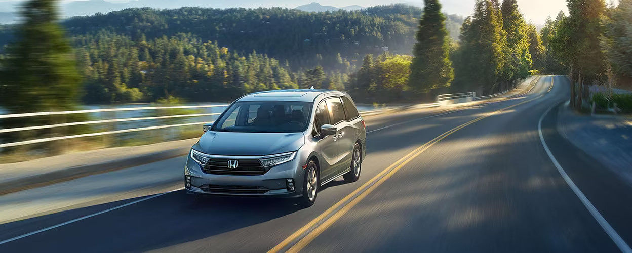 front side view of a 2023 Honda Odyssey on a country road