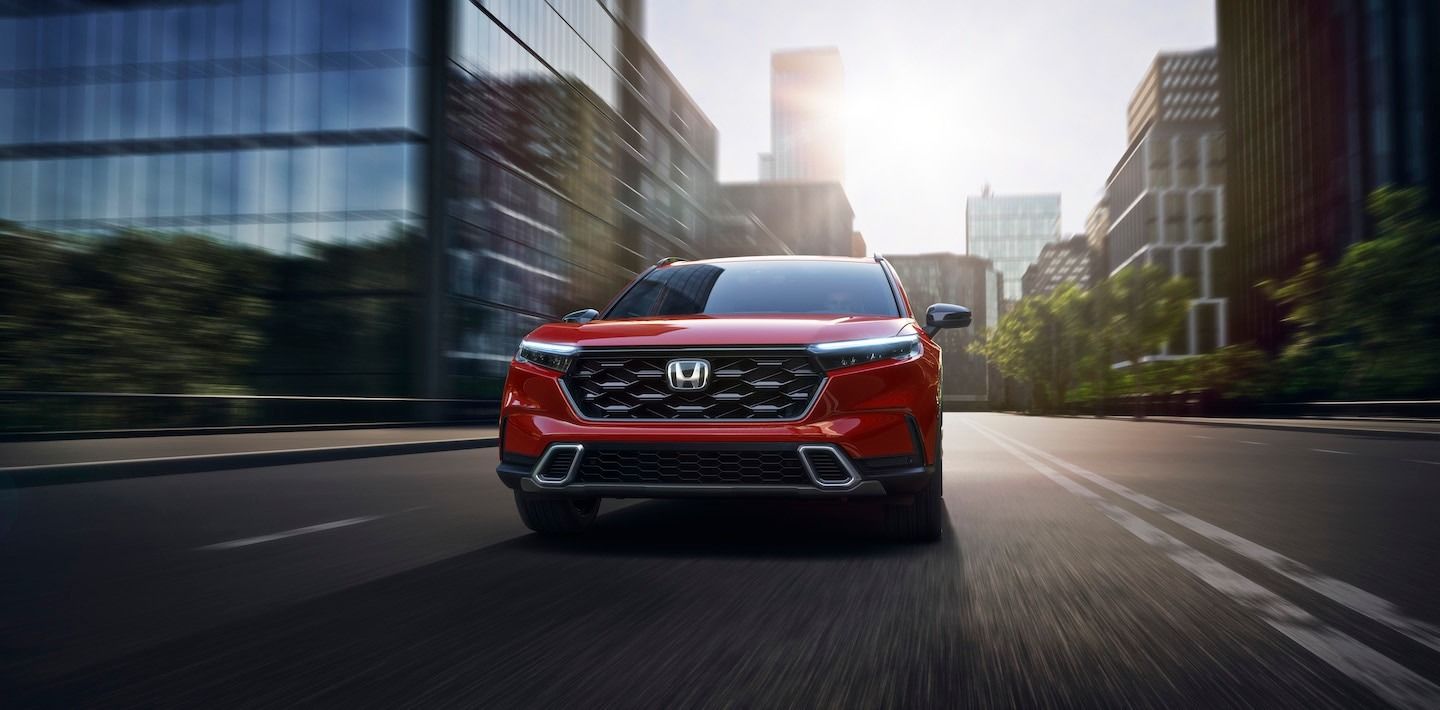 Front view of the 2023 Honda CR-V driving down a city boulevard.
