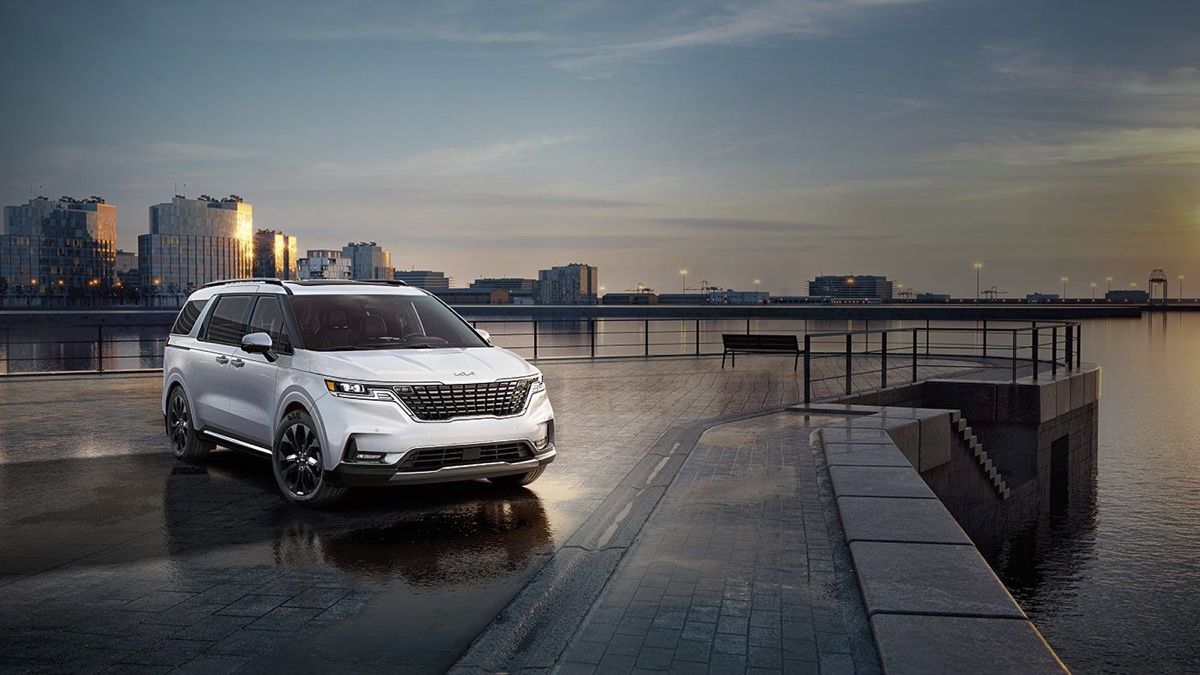 Le Kia Carnival 2024 sur le quai d'un port en pleine nuit.