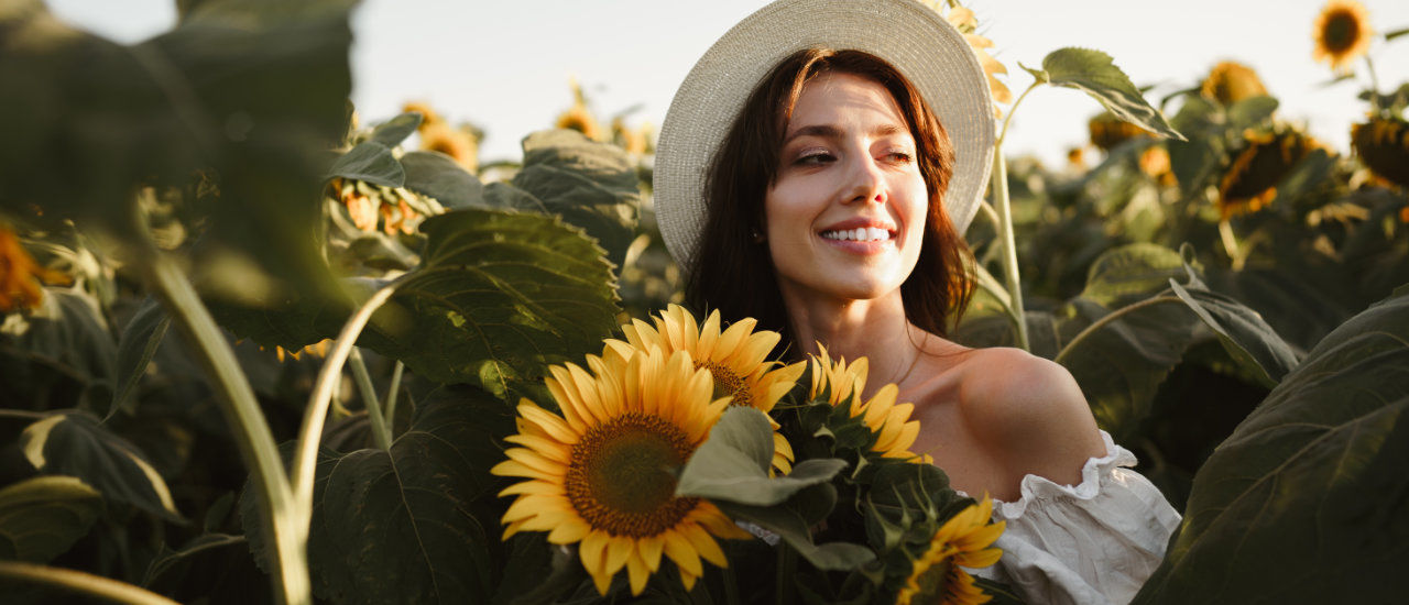 young woman taking a stroll in a sunflower field