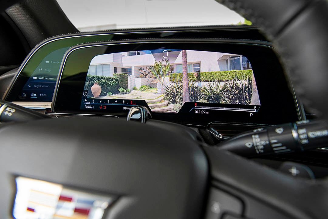view of the steering wheel and of the dashboard screen displaying the rear view camera inside of the 2022 Cadillac Escalade