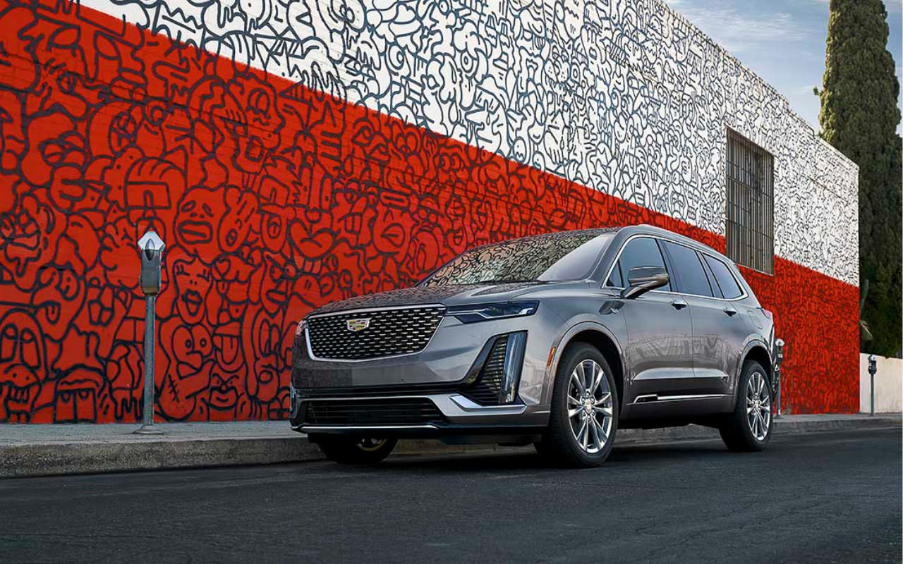 three quarter front view of the 2022 Cadillac XT6 parked on a street