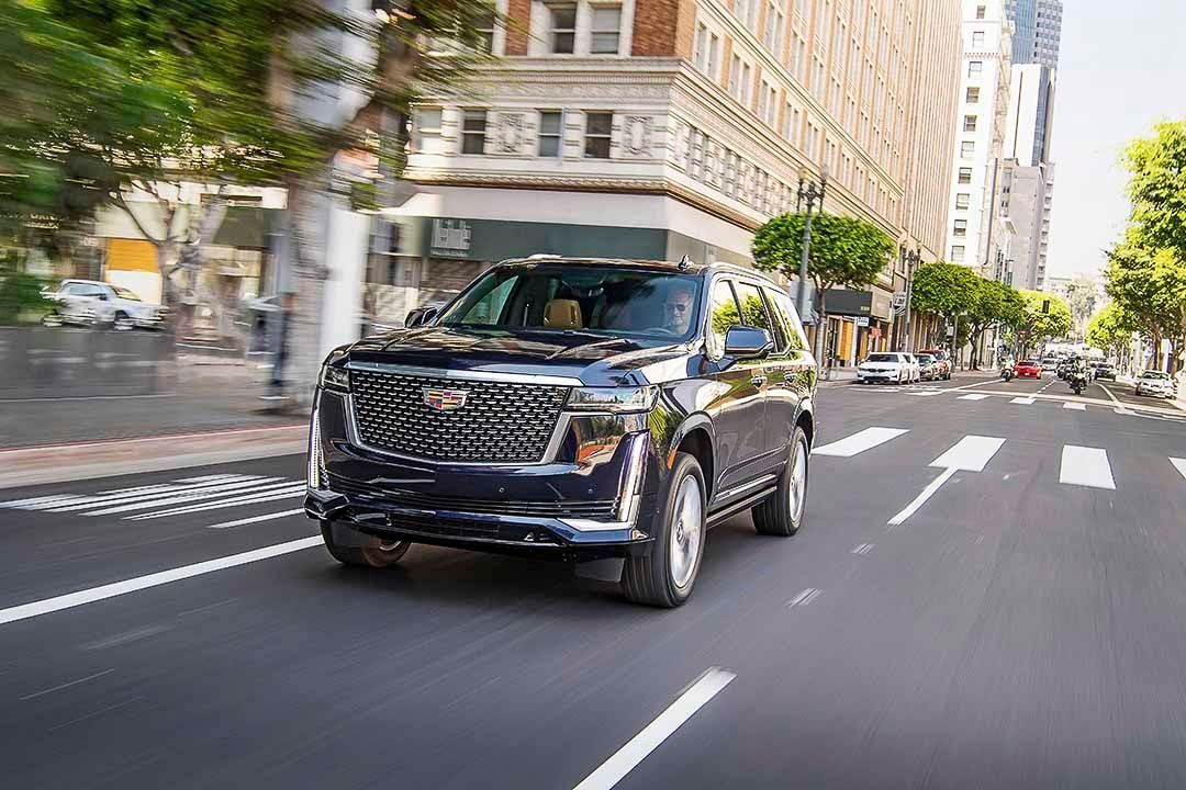 three quarter front view of the 2021 Cadillac Escalade on a city street