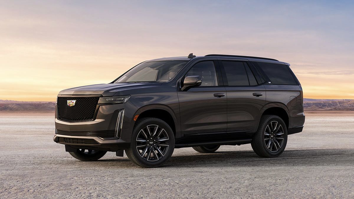 The Cadillac Escalade 2024 parked on the sand.