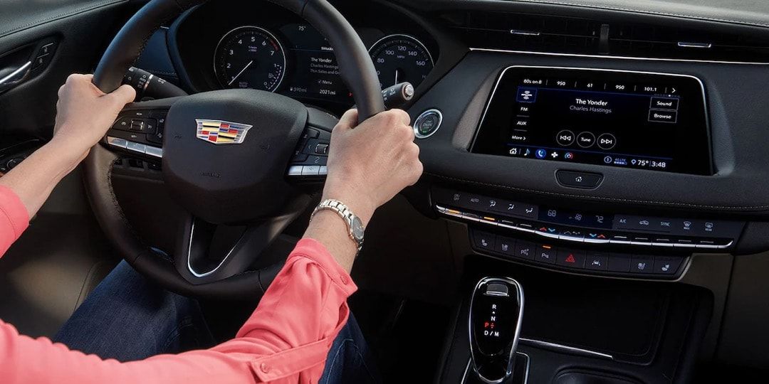 Hands driving the 2023 Cadillac XT4.
