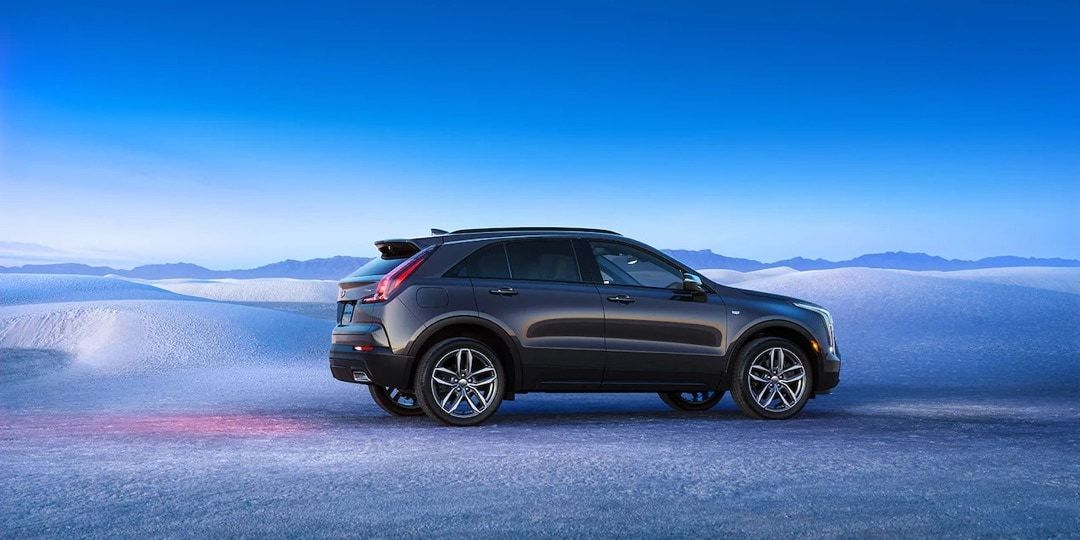 Side view of 2023 Cadillac XT4 on desert land during winter season.