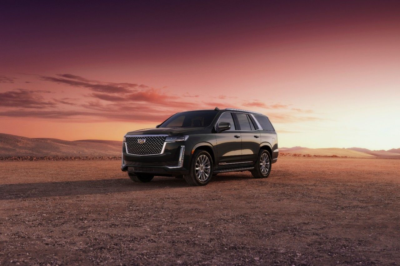Front 3/4 view of 2023 Cadillac Escalade parked on desert land.