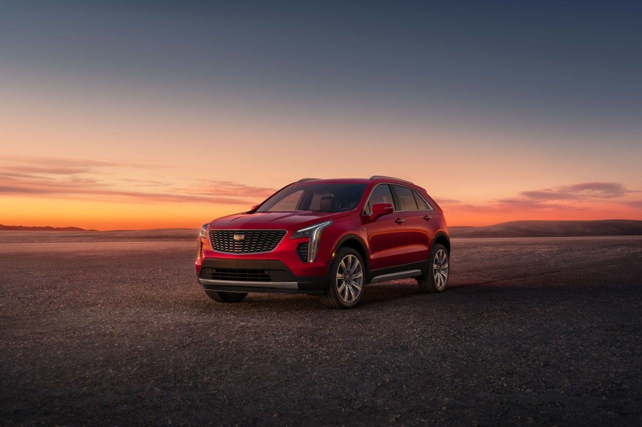 Front 3/4 view of 2023 Cadillac XT4 parked on empty land.