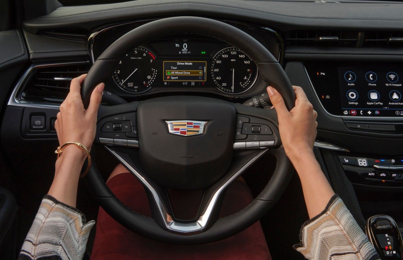 Hands driving the 2023 Cadillac XT6.