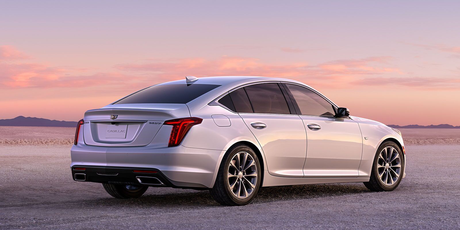 Rear 3/4 view of 2023 Cadillac CT5 parked on desert land.