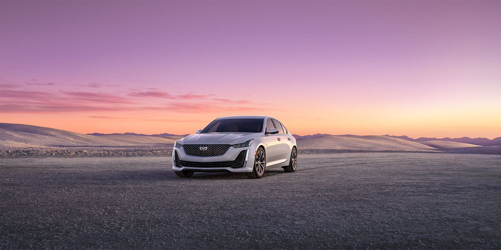 Front 3/4 view of 2023 Cadillac CT5 parked on desert land.