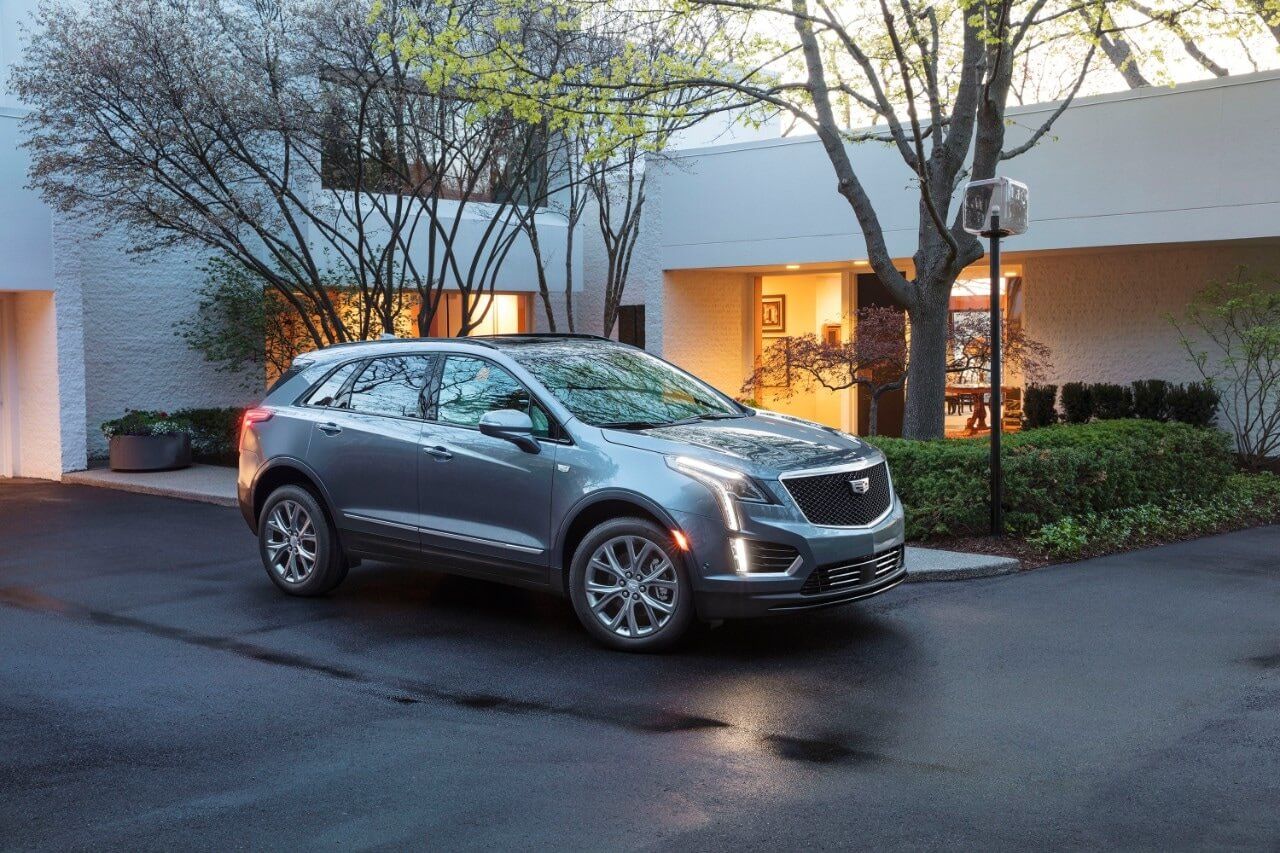 2020 Cadillac XT5 Sport, parked in a house entrance with trees and bushes garden