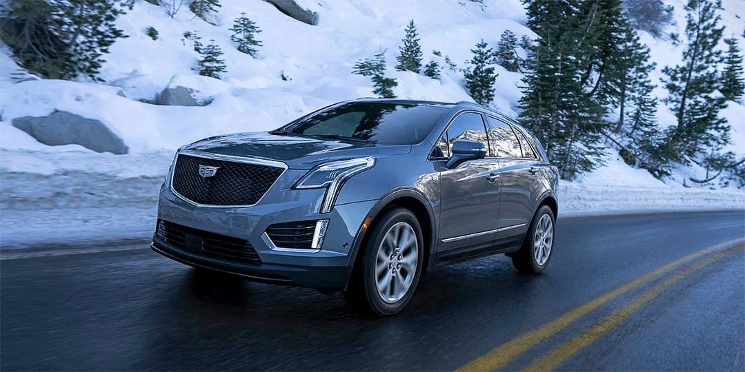 The gray 2021 Cadillac XT5 on the road during the winter season