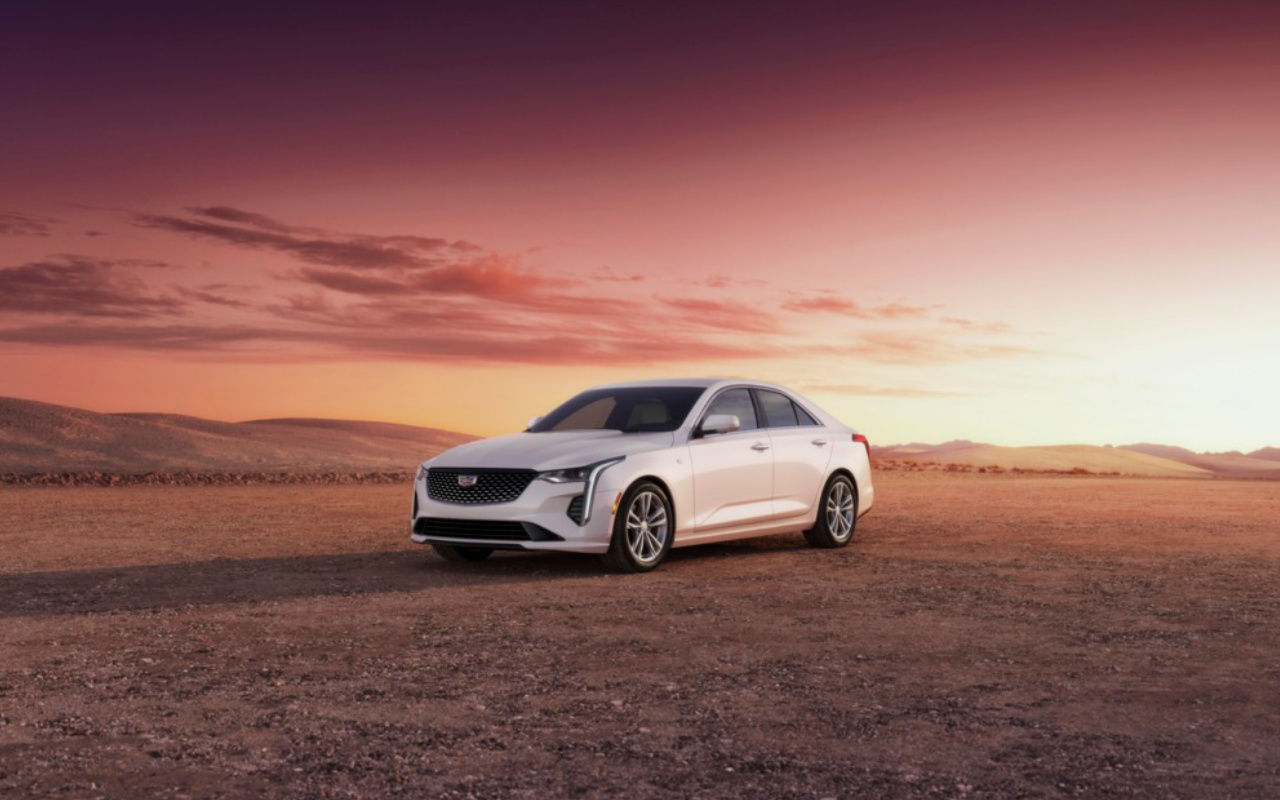 front side view of a 2023 Cadillac CT4 luxury in the desert at dusk
