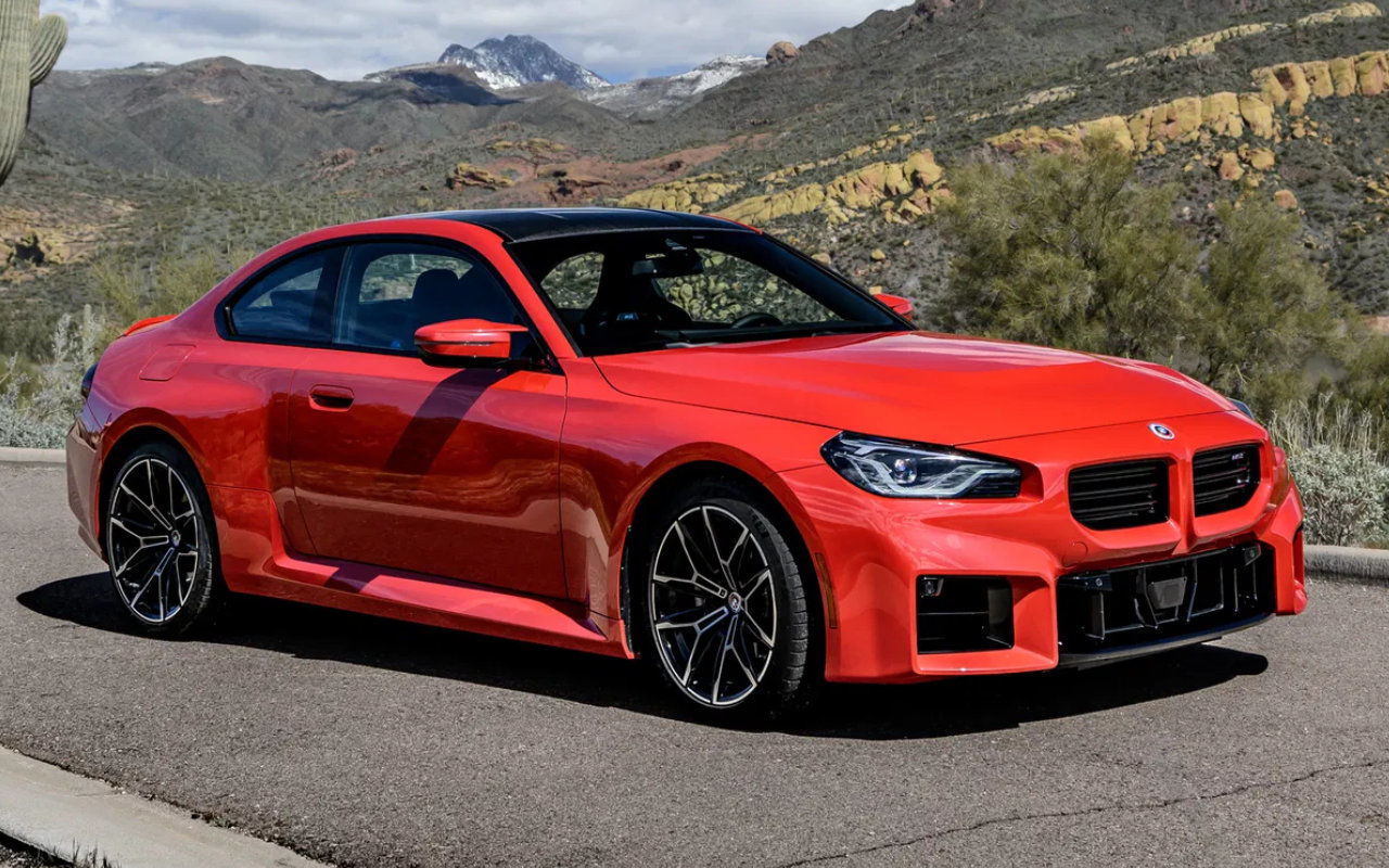 front side view of a 2023 BMW M240i on a mountain road