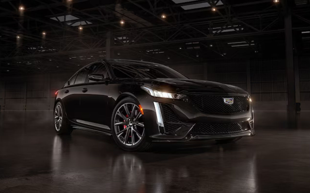 front side view of a 2024 d'une Cadillac CT5 V Blackwing ina dark hangar
