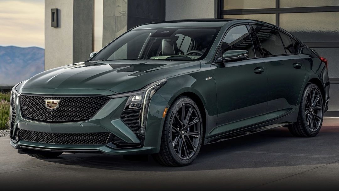 Front 3/4 view of the Cadillac CT5 2025 parked in front of a residential garage.