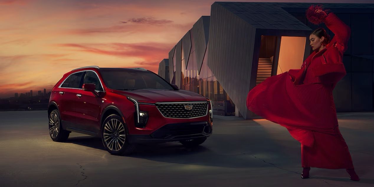 The Cadillac XT4 parked in front of a building at sunset.