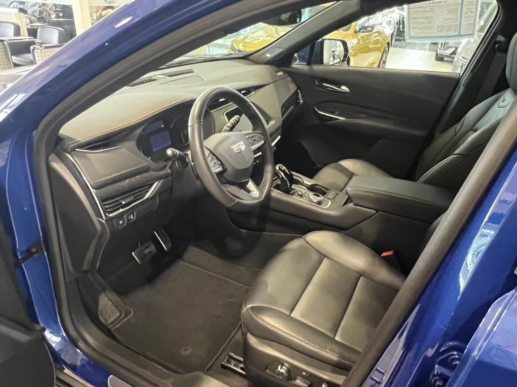 View of the front seats and dashboard console of a used Cadillac XT4.